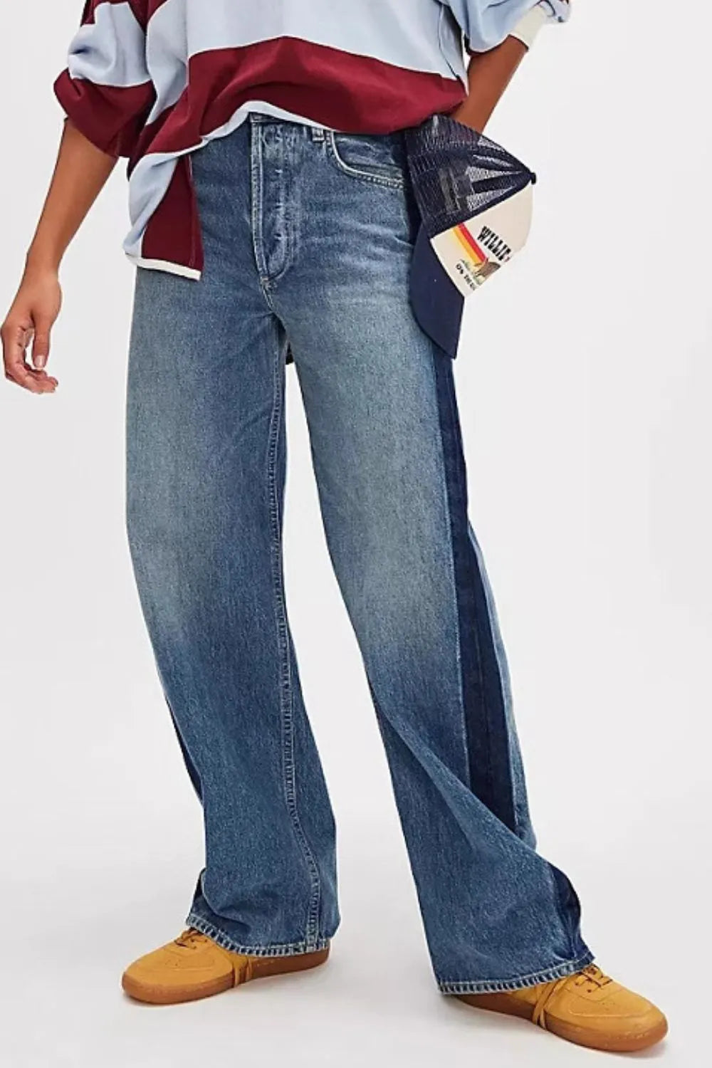 Person wearing blue jeans with a white background