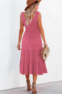 Woman wearing a pink dress with a white background