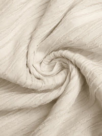 Close-up of beige fabric with a textured pattern
