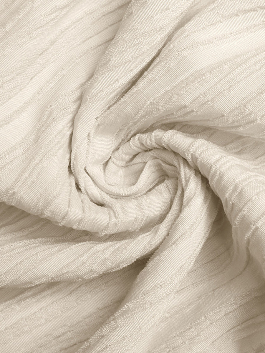 Close-up of beige fabric with a textured pattern
