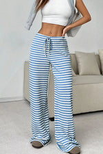 Person wearing blue and white striped pants in a living room setting