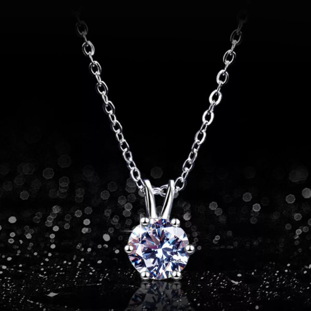Silver necklace with a round diamond pendant on a black background