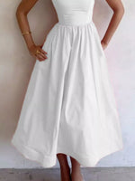 White dress worn by a person against a plain background