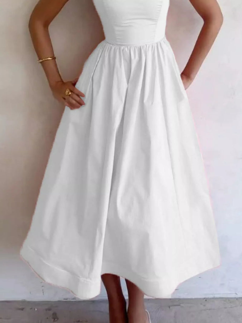 White dress worn by a person against a plain background