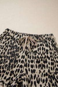 Leopard print shorts with drawstring on a beige background