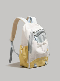 White and yellow backpack on a light gray background