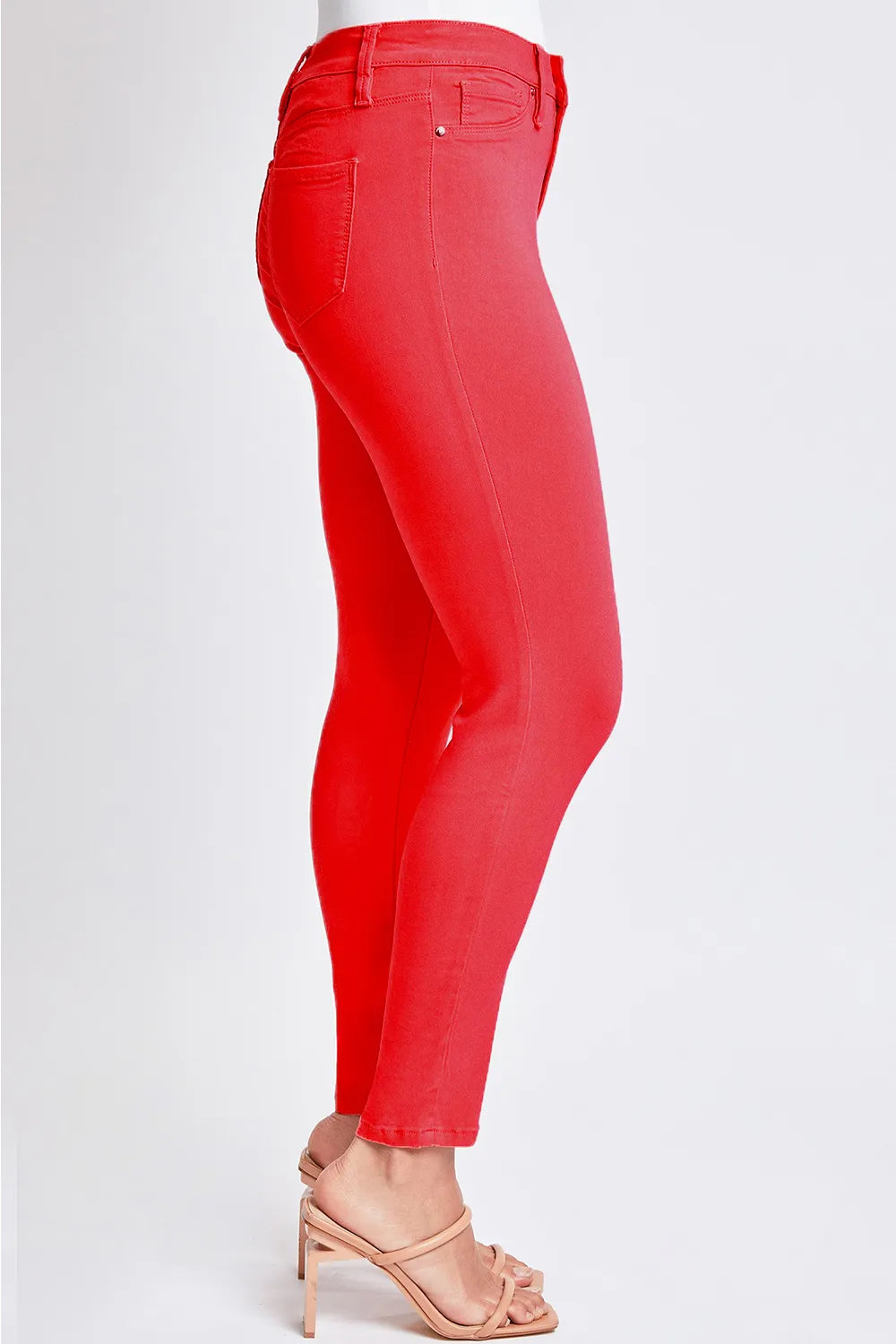 Red jeans worn by a person on a white background