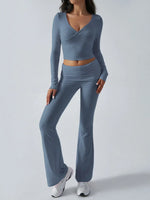 Woman wearing a blue long-sleeve top and pants on a white background