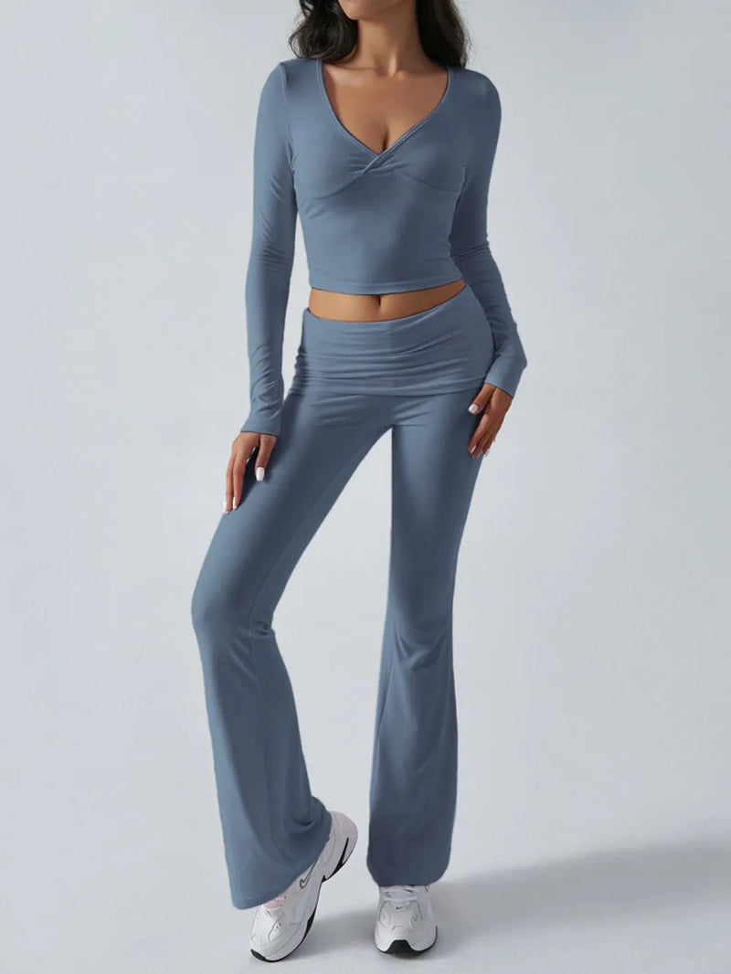 Woman wearing a blue long-sleeve top and pants on a white background