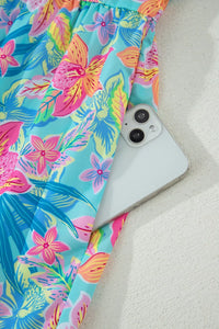 Phone case with colorful floral pattern on a sandy background