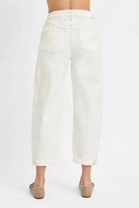 White jeans worn by a person on a white background