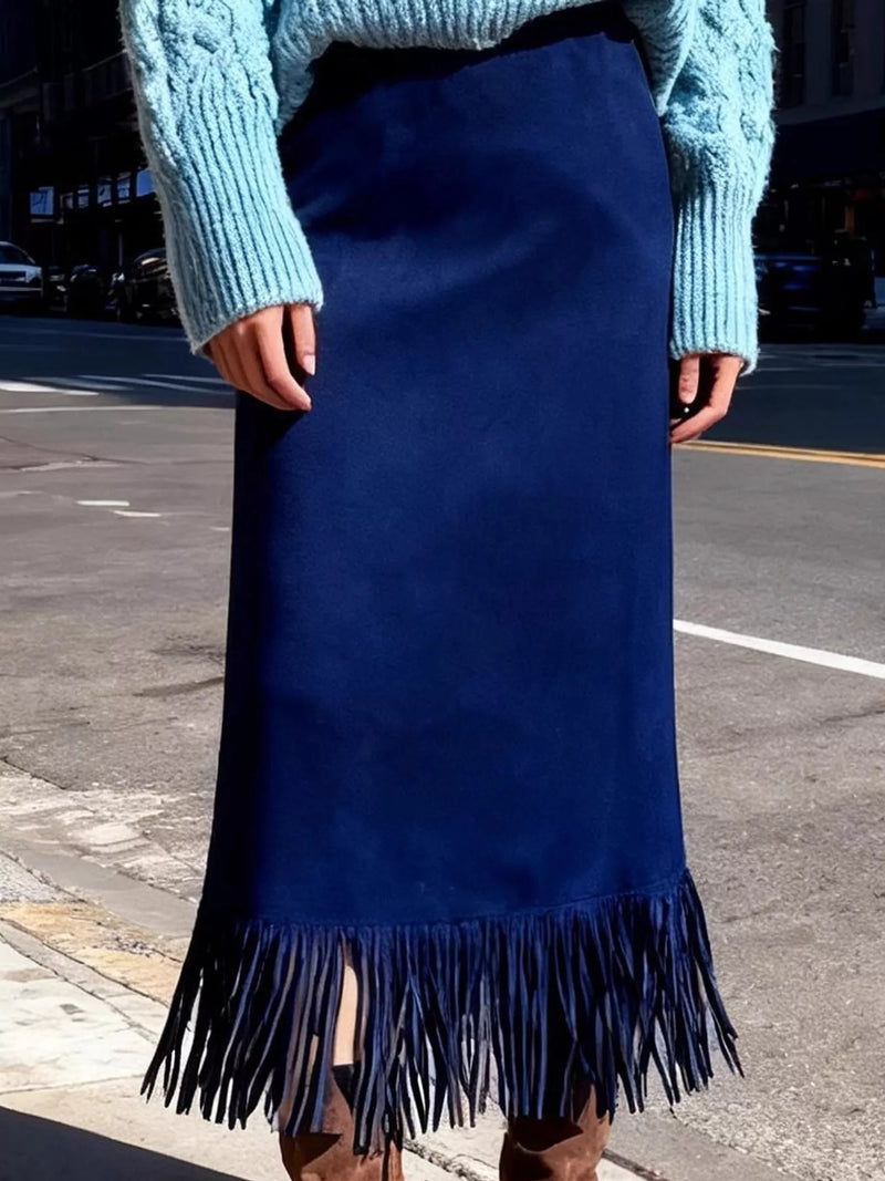 A picture of a lady wearing the blue fringe skirt and blue sweater