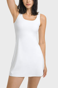 White sleeveless dress worn by a model on a light gray background