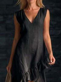 Woman wearing a black sleeveless dress against a dark background