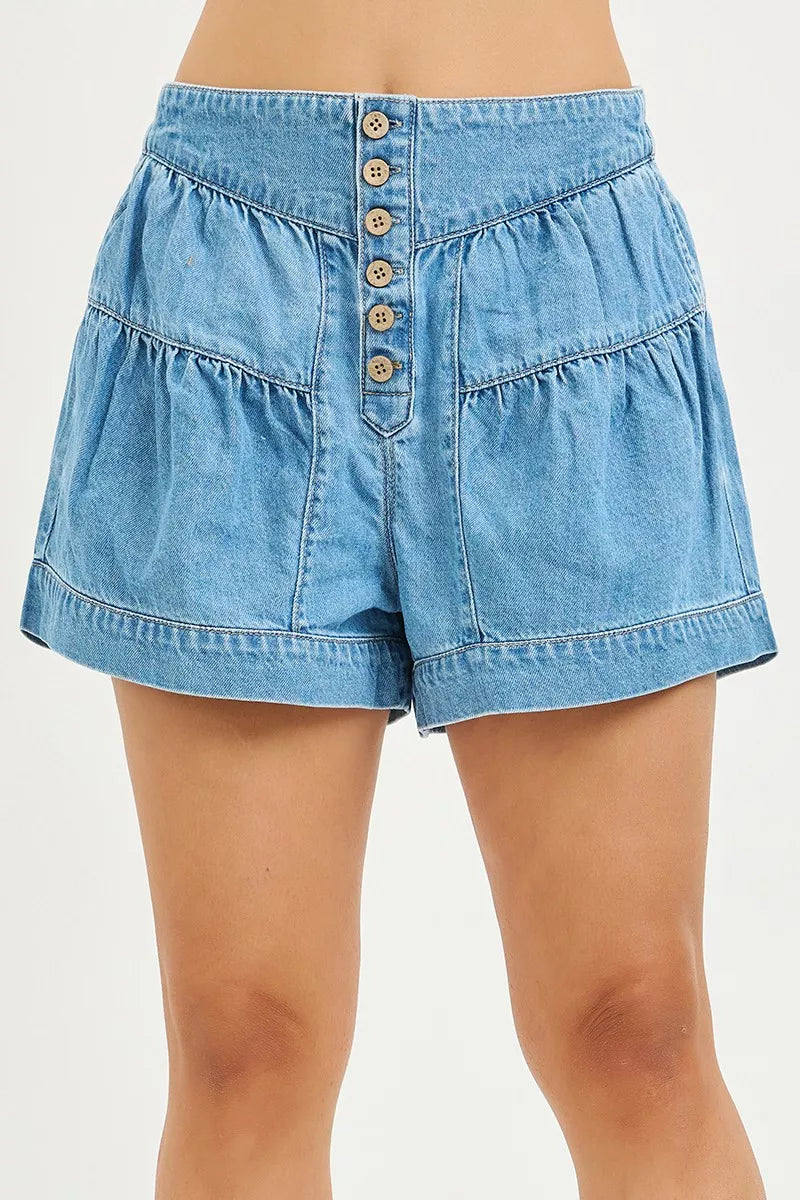 Blue denim shorts with button details on a white background