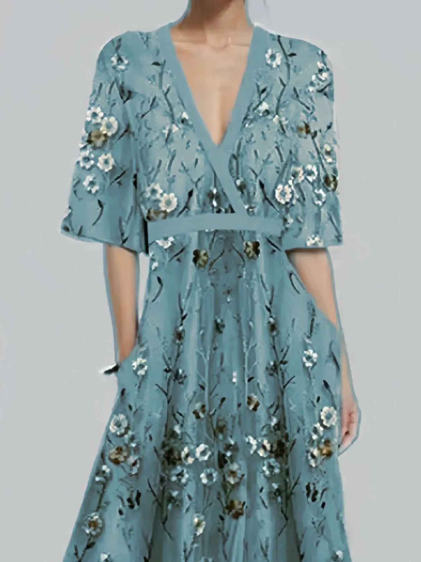 Light blue floral dress on a plain background