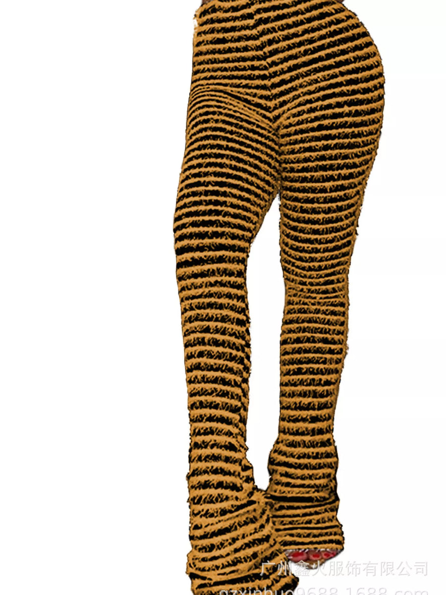 A pair of high-waisted, flared leggings with a textured, ribbed knit pattern in black and mustard yellow, shown on a white background.