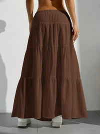 Brown tiered skirt worn by a person on a plain background