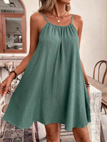 Woman wearing a green dress in an indoor setting