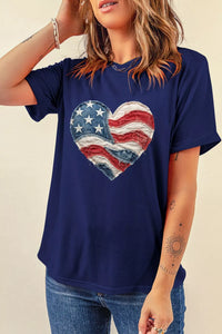 Person wearing a navy blue t-shirt with a heart-shaped American flag design.