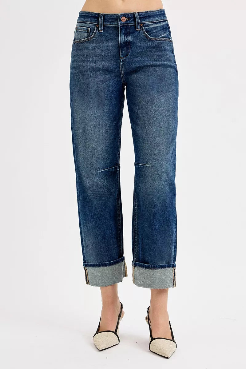 Blue jeans with rolled-up cuffs on a white background