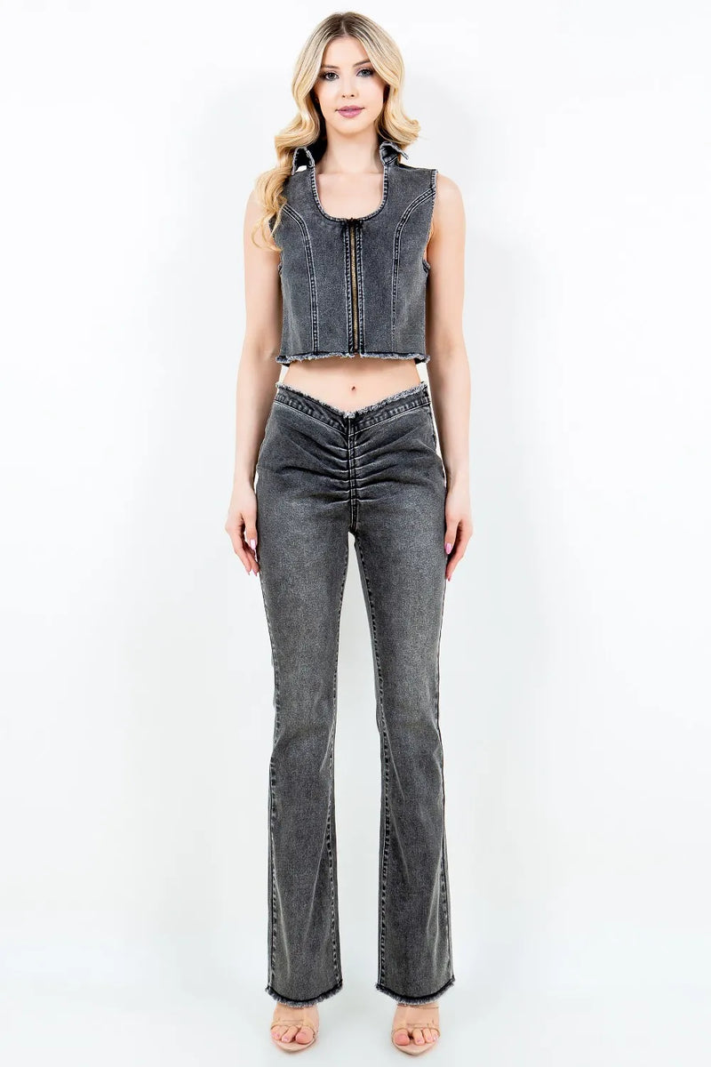 Woman wearing a denim vest and jeans on a white background