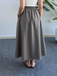 Person wearing a gray skirt in an indoor setting