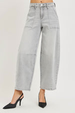 Light gray wide-leg jeans worn by a person on a plain background