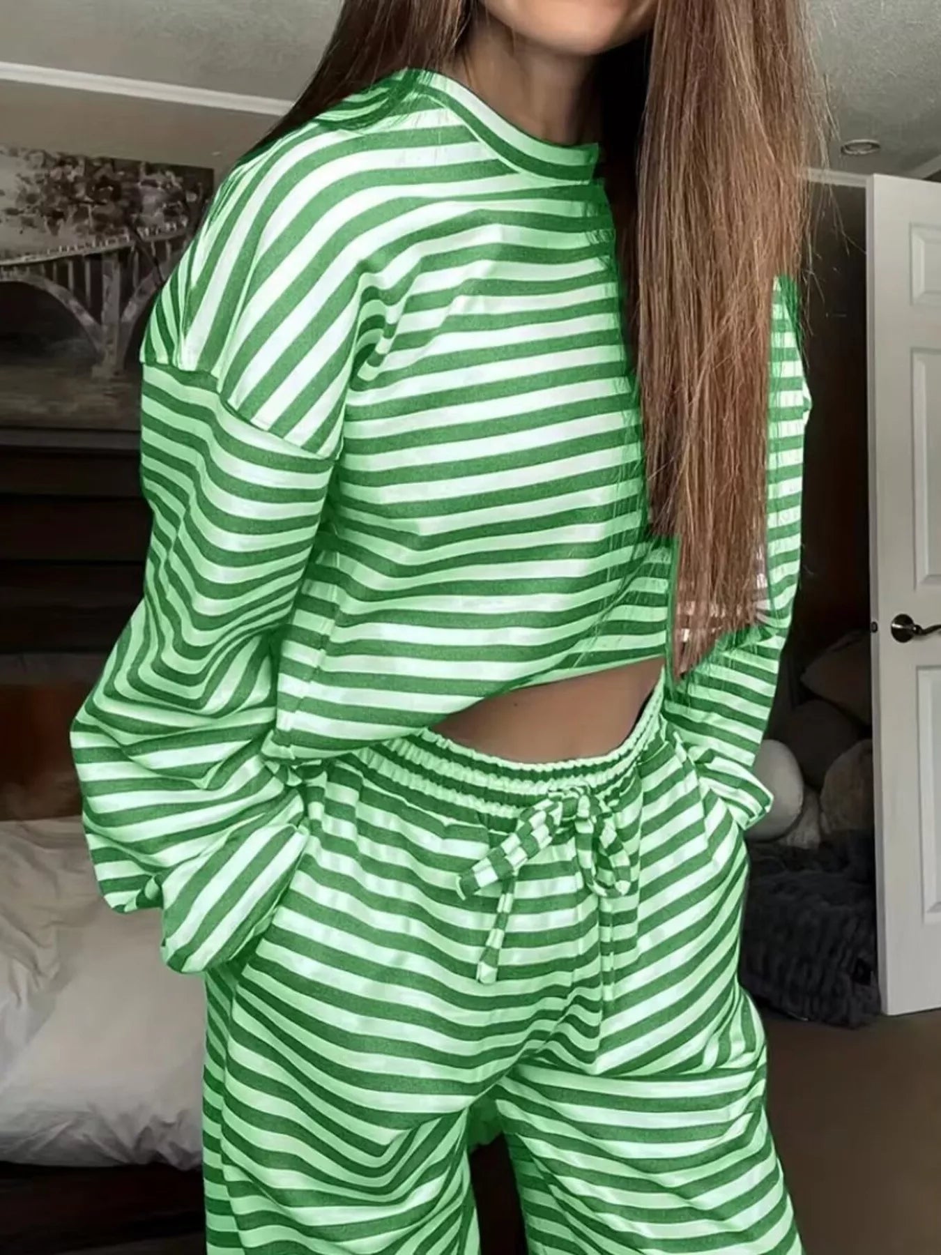 Person wearing a green and white striped outfit in a room.