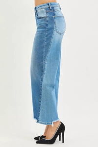 Blue jeans worn by a person on a white background