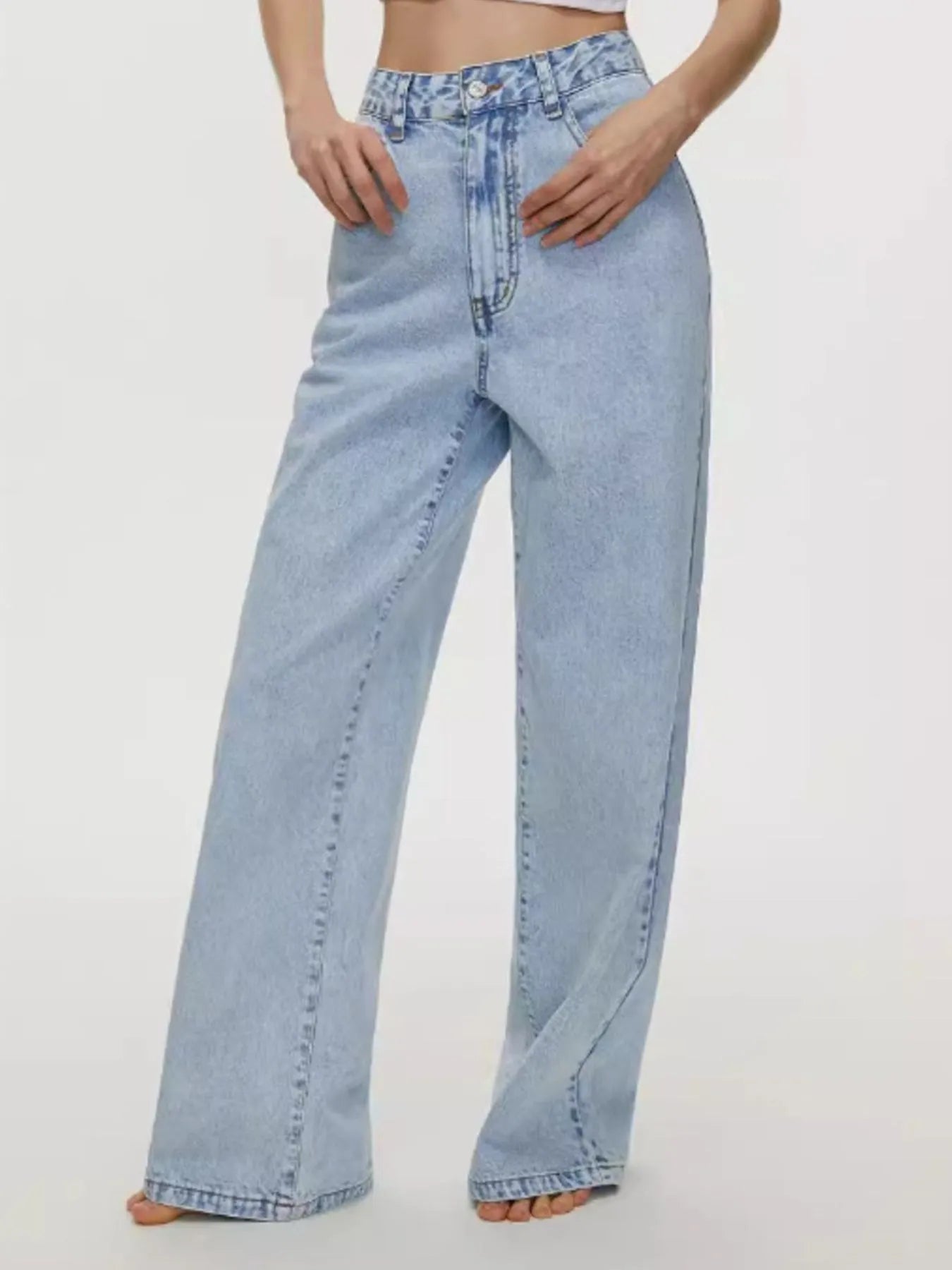 Light blue jeans worn by a person on a white background