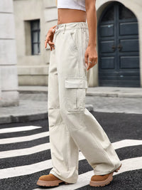 Person wearing beige cargo pants on a city street