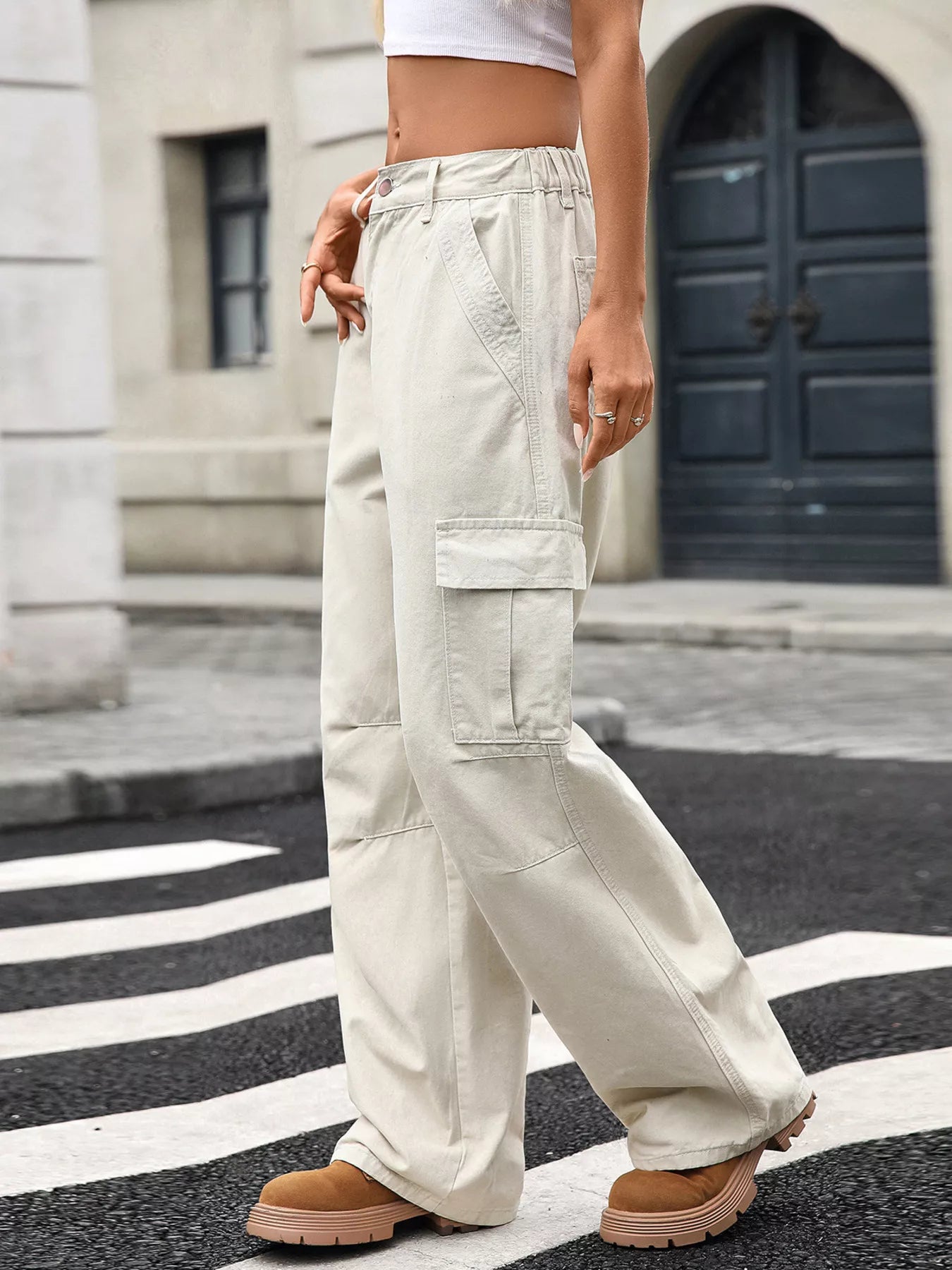 Person wearing beige cargo pants on a city street