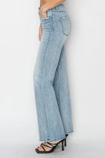 Light blue jeans worn by a person on a white background