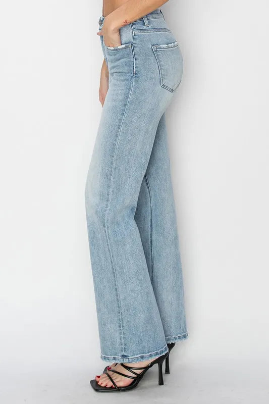 Light blue jeans worn by a person on a white background