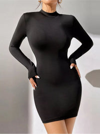 Black long-sleeve dress worn by a model on a plain background