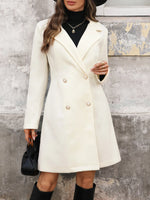 Woman wearing a white coat with a textured wall background