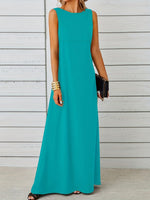 Teal sleeveless dress worn by a person against a wooden background