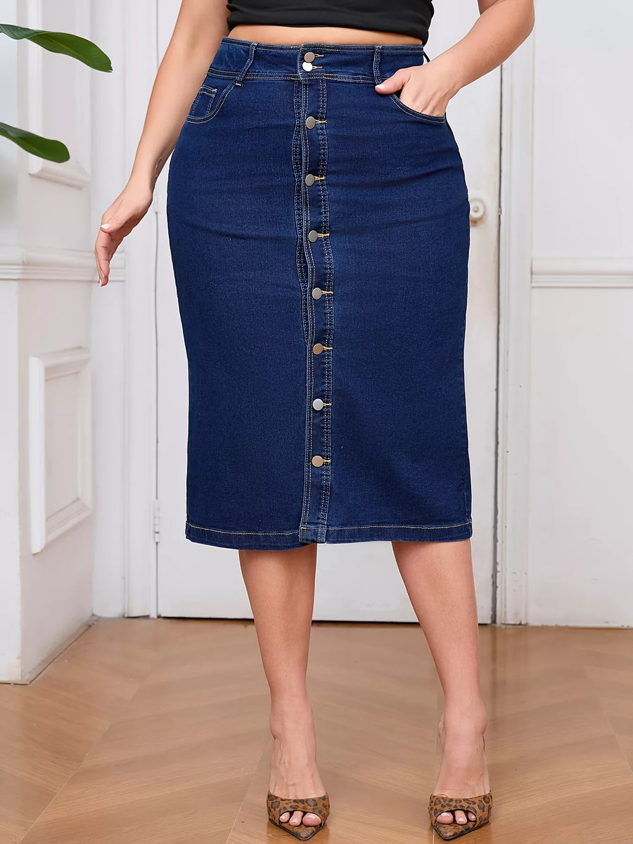Person wearing a blue denim skirt with button details on a wooden floor.