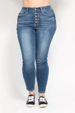 Blue jeans worn by a person on a white background