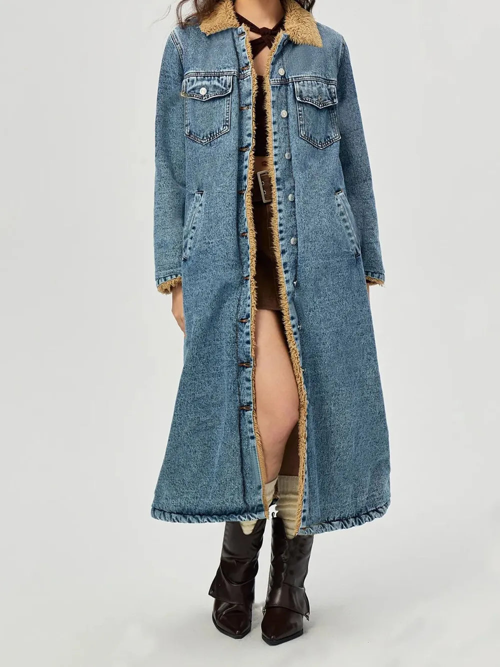 Long denim coat with fur trim on a white background