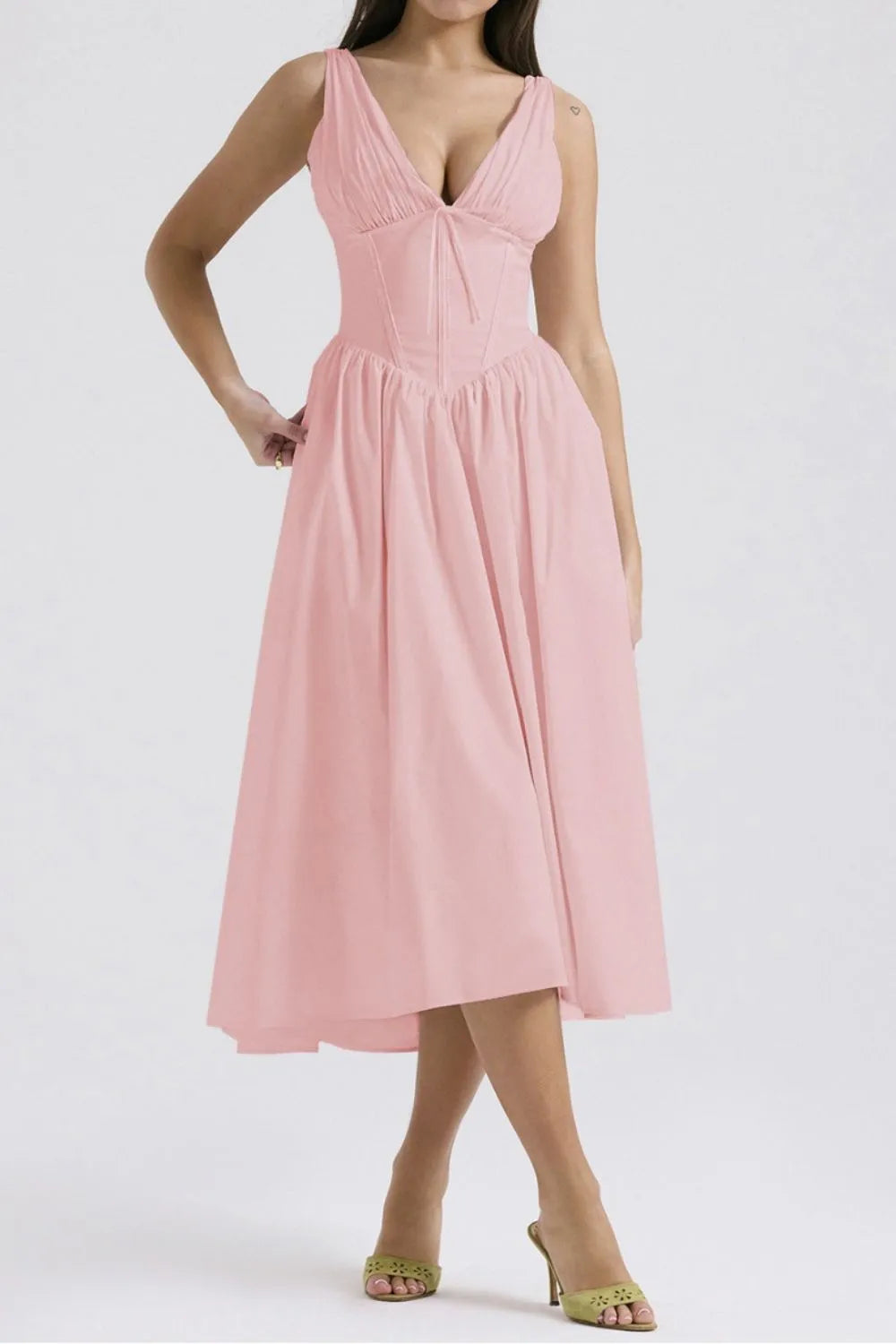 Pink dress worn by a model on a white background