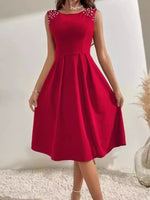 Red dress with beaded shoulders on a plain background