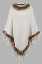 White poncho with brown fur trim on a gray background