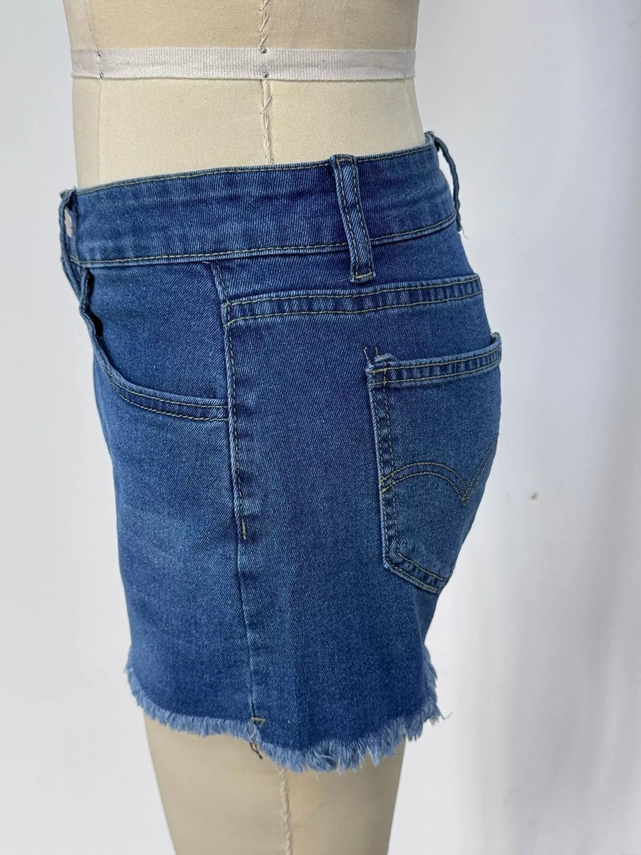 Blue denim skirt on a mannequin against a white background