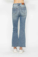 Light blue flared jeans on a white background