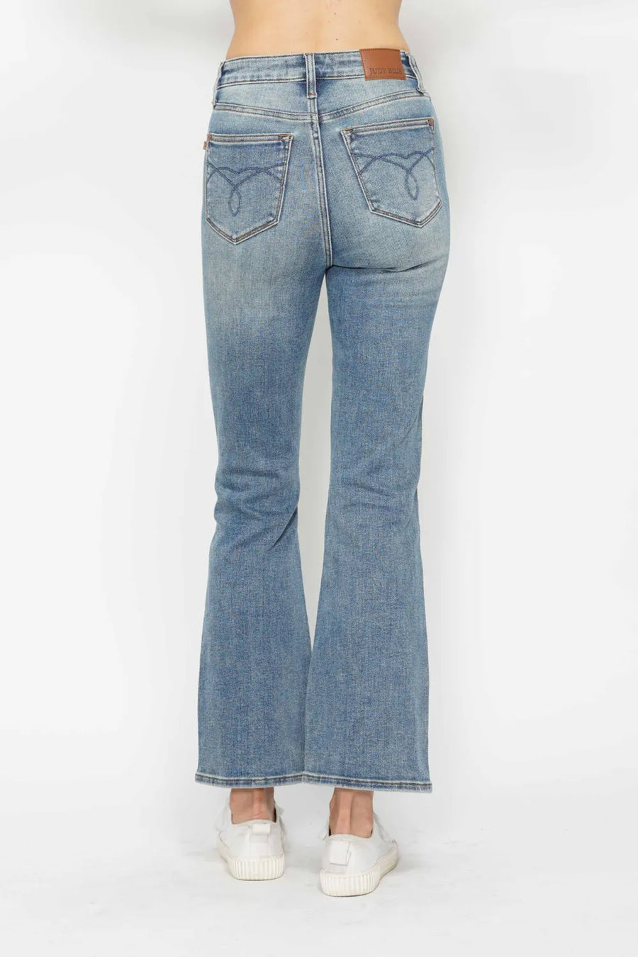 Light blue flared jeans on a white background