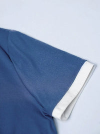 Close-up of blue fabric with white trim on a light gray background