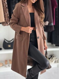 Woman wearing a brown coat in a clothing store setting