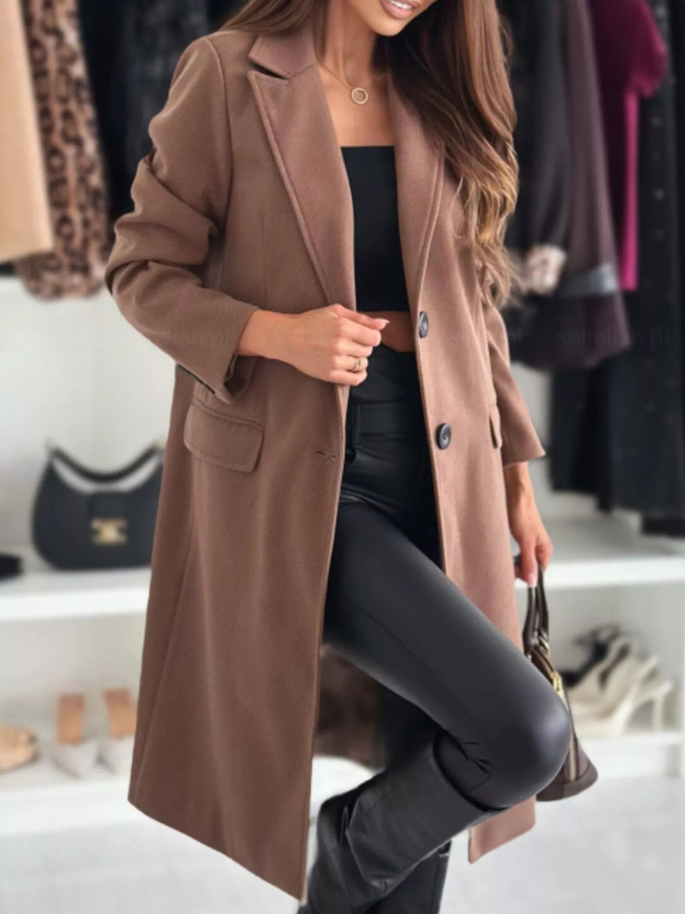 Woman wearing a brown coat in a clothing store setting